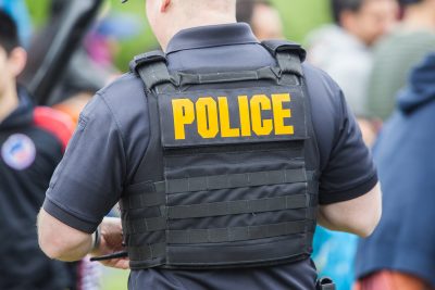 Police officer standing in a crowd.